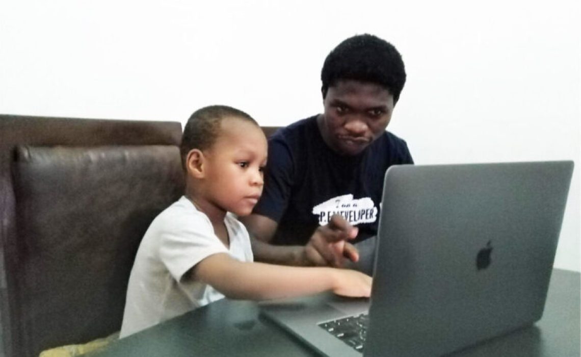 FILE PHOTO: A parent uses a laptop to guide his son to access online lessons PHOTO: Internet
